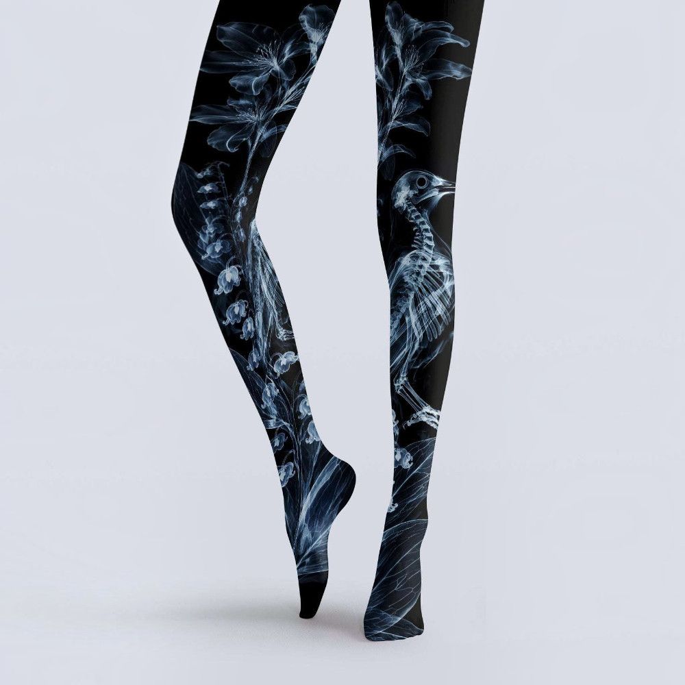 Avaeri black tights printed with white X-ray-style floral and bird skeleton patterns, made of stretch fabric, ideal for dark romantic style outfits.