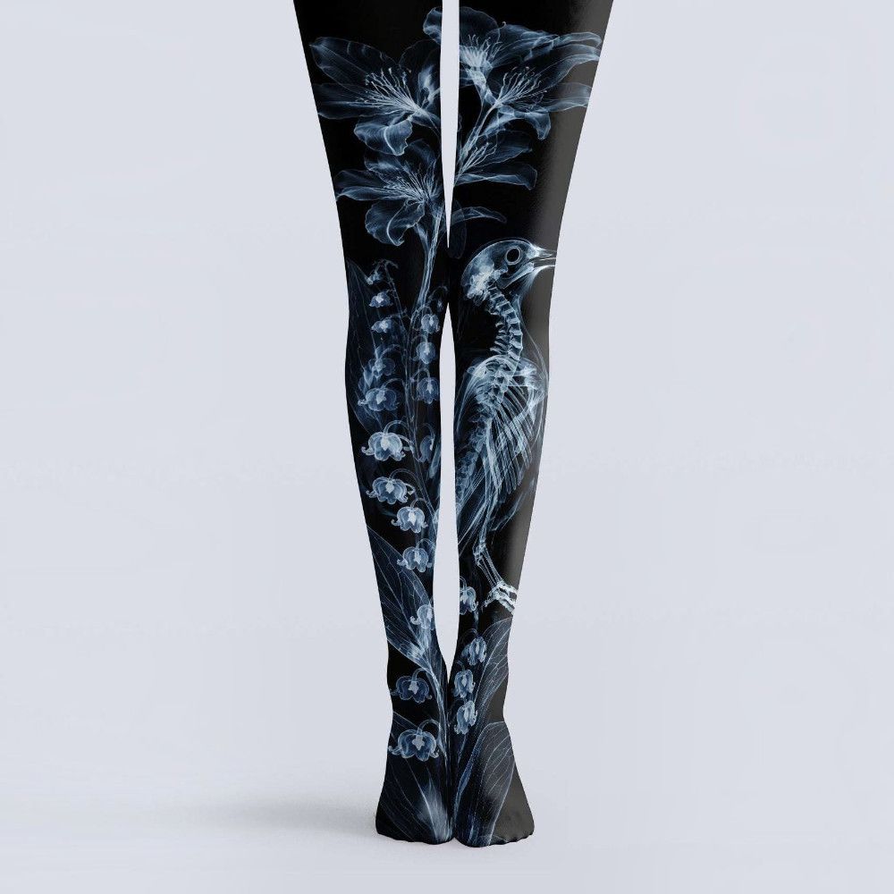 Avaeri black tights are printed with white X-ray-style patterns of flowers and bird skeletons, crafted from comfortable stretch fabric to showcase a dark romantic aesthetic.